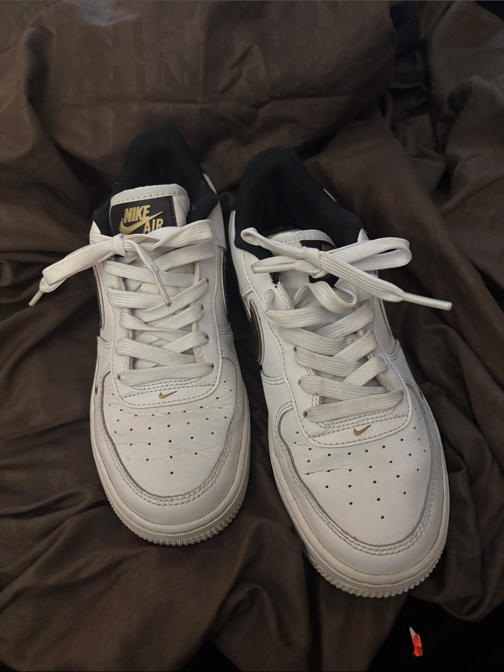 Nike Air Low-Top White Sneakers with Black Collar and Gold Swoosh